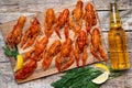 beer and beautiful boiled crayfish on a wooden table and wooden board with dill and lemon Royalty Free Stock Photo