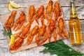 beer and beautiful boiled crayfish on a wooden table and wooden board with dill and lemon Royalty Free Stock Photo