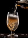Beer is being poured into a glass on a black background Royalty Free Stock Photo