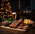 Beer being poured into glass with gourmet steak and french fries on christmas background Royalty Free Stock Photo