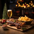 Beer being poured into glass with gourmet steak and french fries on christmas background Royalty Free Stock Photo