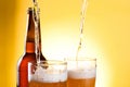 Beer Being Poured in Two glasses and Bottle Royalty Free Stock Photo