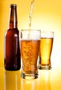 Beer Being Poured in Two glasses and Bottle Royalty Free Stock Photo