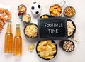 Beer bootles, snacks and ball on table Royalty Free Stock Photo