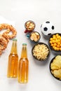 Beer bootles, snacks and ball on table Royalty Free Stock Photo