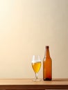 Beer bottle alongside a glass filled with refreshing beer, set against a vibrant yellow background. Royalty Free Stock Photo