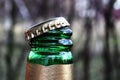 Beer bottle cap. Open bottle of beer. Golden plug, green glass. Royalty Free Stock Photo