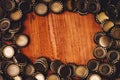 Beer bottle caps frame over wooden background Royalty Free Stock Photo