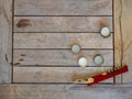 Beer bottle caps and bottle opener sitting on wooden table outdoors at party event Royalty Free Stock Photo