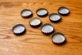 Beer bottle caps on a wooden table Royalty Free Stock Photo