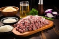 beer bottle, diced onions, and a plate of sausages: preparation scene