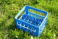 Beer bottle empty plastic crate on grass Royalty Free Stock Photo