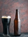 Beer bottle and glass with dark beer porter or stout