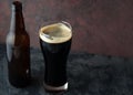 Beer bottle and glass with dark beer porter or stout