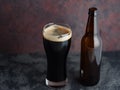 Beer bottle and glass with dark beer porter or stout