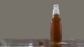 Beer bottle with openned bottlecap, foam split out on table Royalty Free Stock Photo