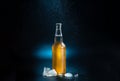 amber beer bottle, splashing drops on a black and blue background. A beer bottle with splashing drops with ice chunks on