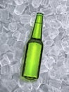 Beer bottle with water drops of cold beverage, ice cube a of juicy. Summer refreshing drink Royalty Free Stock Photo