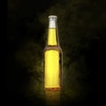 Beer bottle with water drops on the yellow color smoke black background Royalty Free Stock Photo