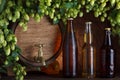 Beer bottles with beer barrel and fresh hops Royalty Free Stock Photo