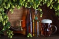 Beer bottles with glass of beer and barrel