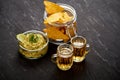 Beer and a bowl of guacamole with nachos on an old black wooden table Royalty Free Stock Photo