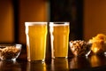 Beer business in pub. Glasses of lager, pistachios, chips and nuts on wooden table in interior