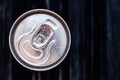 Beer can with condensation on black background. Aluminium can of drink with water drops, refrigerated cola can, top view. Text Royalty Free Stock Photo