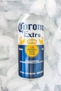 A beer can of a Corona Extra in a bed of ice