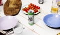 Beer can on wooden table with dishes