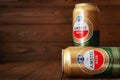 Beer cans with water drops. AMSTEL beer in cans covered with condensation. World famous Dutch brand. Wooden background with copy Royalty Free Stock Photo