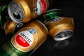 Beer cans. Wet crumpled empty beer cans with water drops on a dark background, top view. AMSTEL is a world famous brand from the