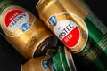 Beer cans. Wet crumpled and full beer cans with condensation drops on a dark background, top view. AMSTEL world famous brand in