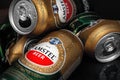 Beer cans. Wet crumpled and full beer cans with water drops on a dark background, top view. AMSTEL is a world famous brand from