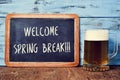 Beer and chalkboard with the text welcome spring break