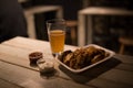 Beer, chicken wings and sauce on the table in pub