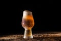 Beer. Cold Craft light Beer in a glass with water drops on the wooden table over the black background Royalty Free Stock Photo