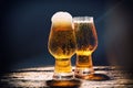 Beer. Cold Craft light Beer in a glass with water drops on the wooden table over the black background Royalty Free Stock Photo