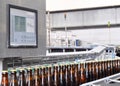 Beer filling in a brewery - conveyor belt with glass bottles Royalty Free Stock Photo