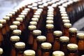 Beer filling in a brewery - conveyor belt with glass bottles Royalty Free Stock Photo