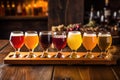 beer flight of different saison beers on a wooden plank