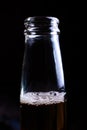 Beer foam in a bottle on a dark background Royalty Free Stock Photo