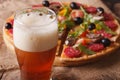 Beer with foam close-up on background pizza Royalty Free Stock Photo