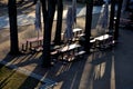 Beer front garden under the crowns of lindens. camping benches and tables with a red plastic surface. beige umbrellas park restaur