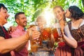 In Beer garden in Bavaria, Germany - friends in Tracht, Dindl and Lederhosen and Dirndl standing in Bavarian beer garden or Royalty Free Stock Photo