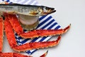 Beer in a glass and an appetizer to beer. Cooked crab and salted dried fish. Striped vest