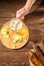 Beer glass with beer and hot smoked fish close-up. Beer mug with beer and potato chips, crackers on a dark background and copy spa Royalty Free Stock Photo