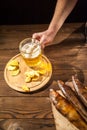 Beer glass with beer and hot smoked fish close-up. Beer mug with beer and potato chips, crackers on a dark background and copy spa Royalty Free Stock Photo