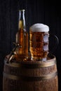 Beer glass and bottle on vintage wooden barrel with old tap Royalty Free Stock Photo