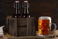 Beer glass with beer bottles in wooden crate Royalty Free Stock Photo